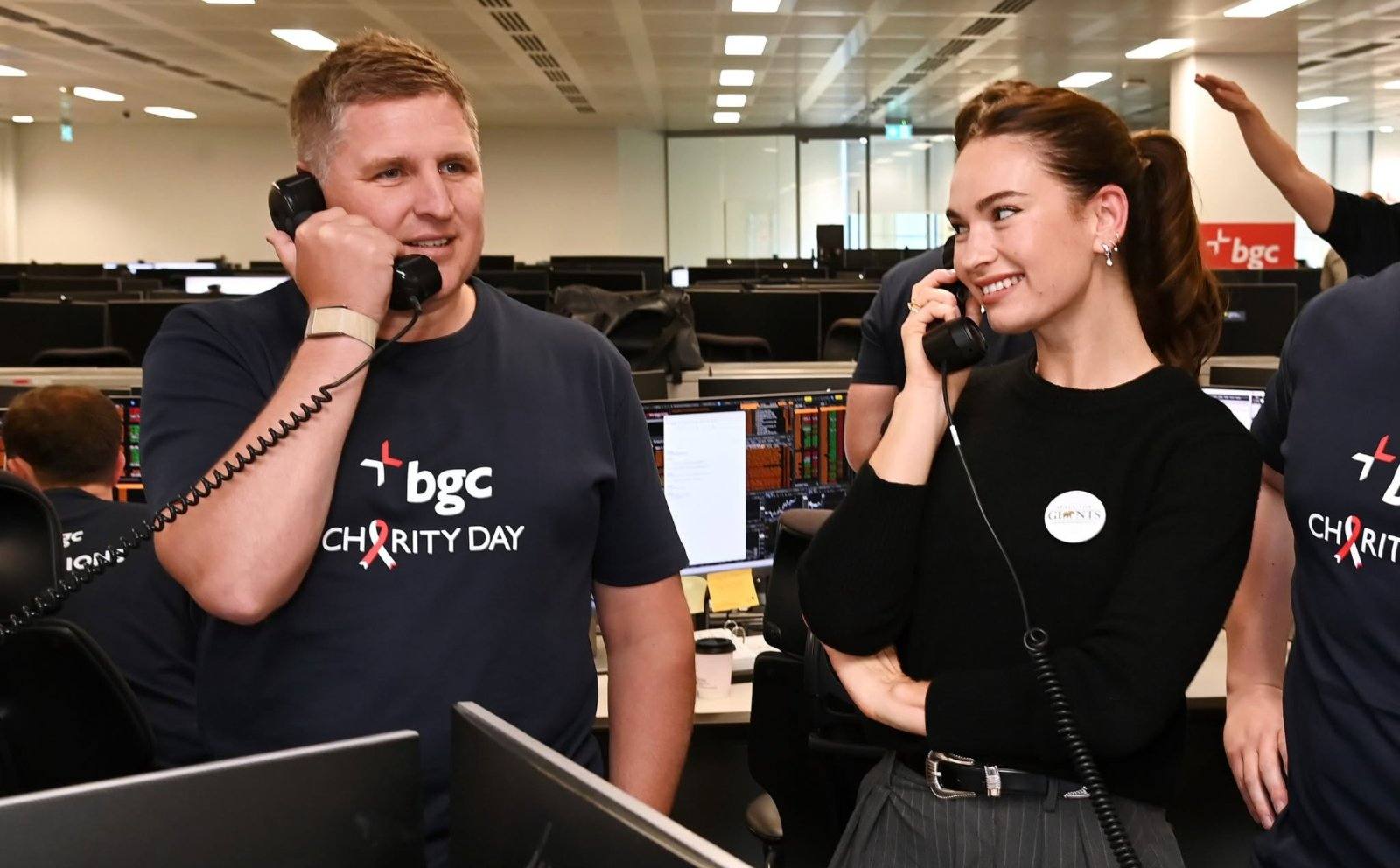 Lily James taking calls on the trading floor