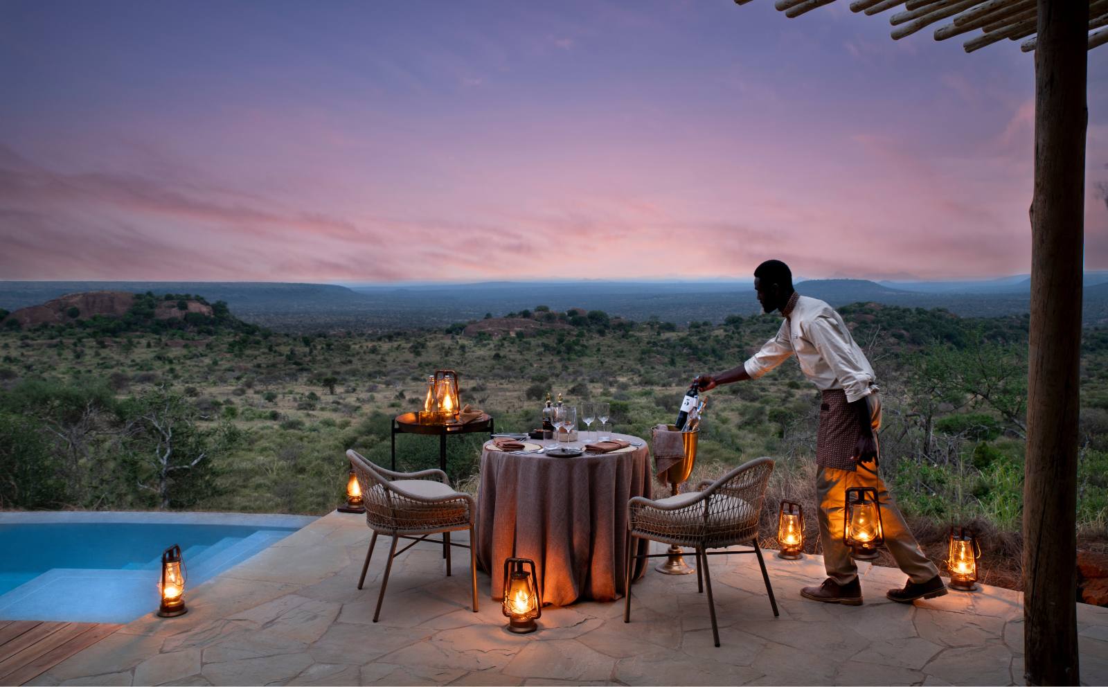 Private dinner set at dusk beside the pool